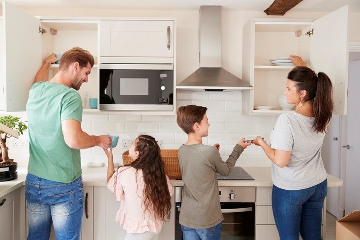 A family putting dishes away.