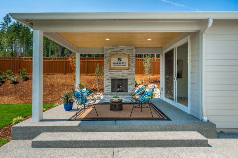 Furnished outdoor seating area featuring a fireplace by Garrette Custom Homes