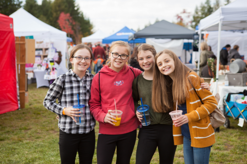 Four preteens pose for a photo at a Tehaleh community event