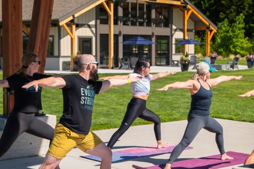 A group from Evolve Strong Fitness practice their yoga poses at Discovery Park