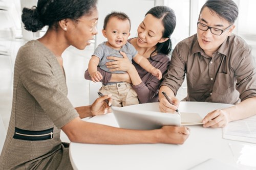 A young family meet with a lender to figure out their home buying options