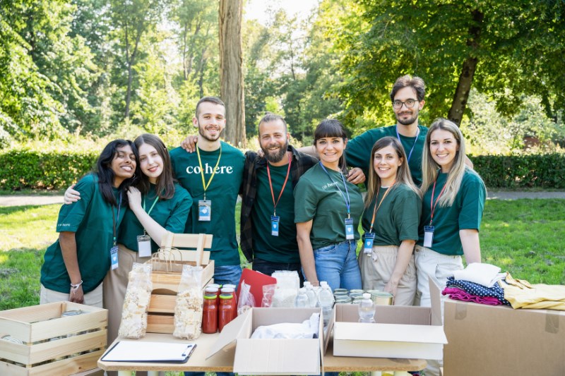 The Cohere team poses for a group photo at an event.